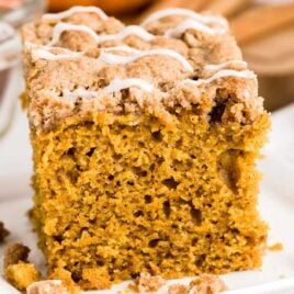 a close up shot of a slice of Pumpkin Coffee Cake on a plate