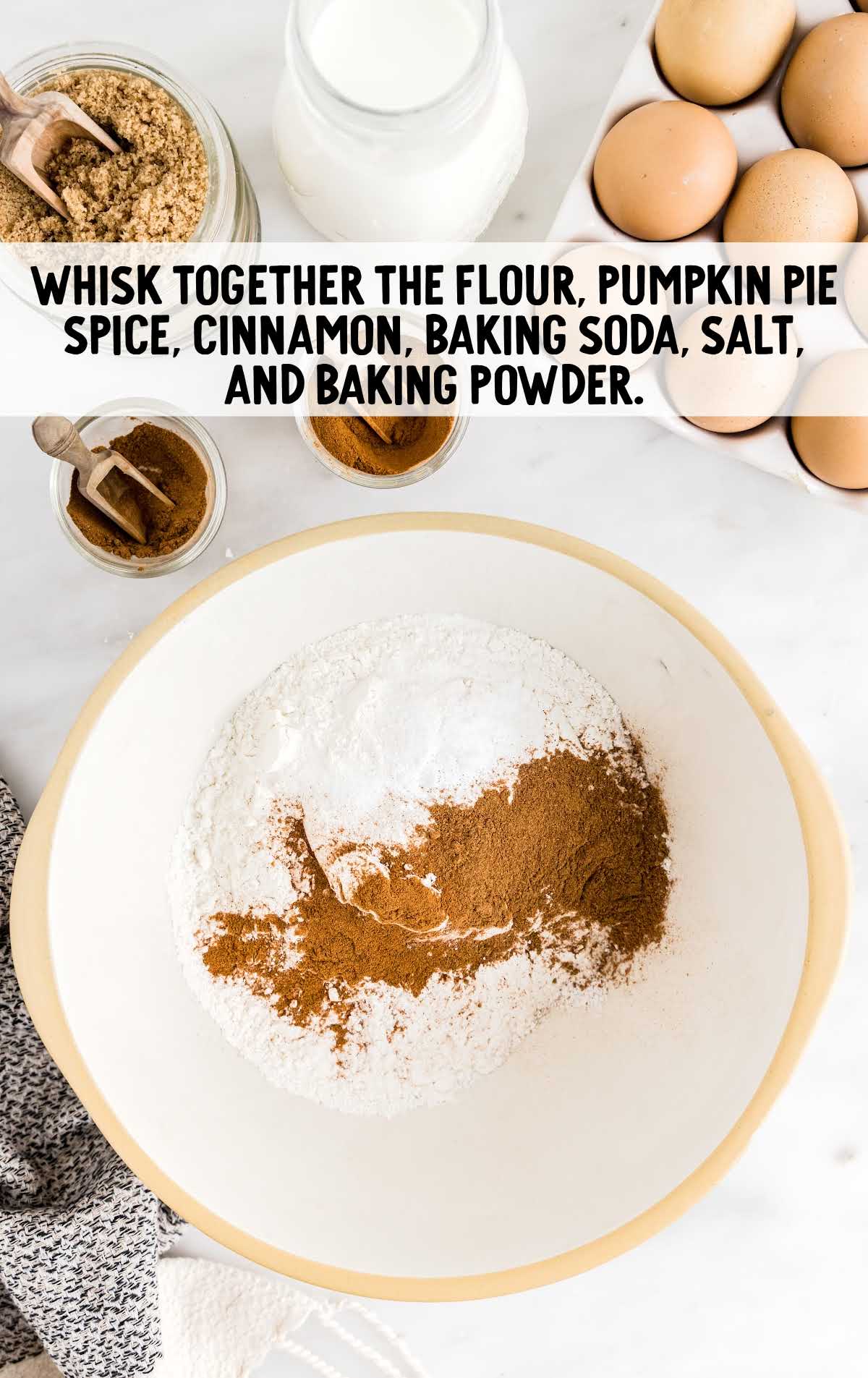 flour, pumpkin pie spice, cinnamon, baking soda, salt, and baking powder whisked in a bowl