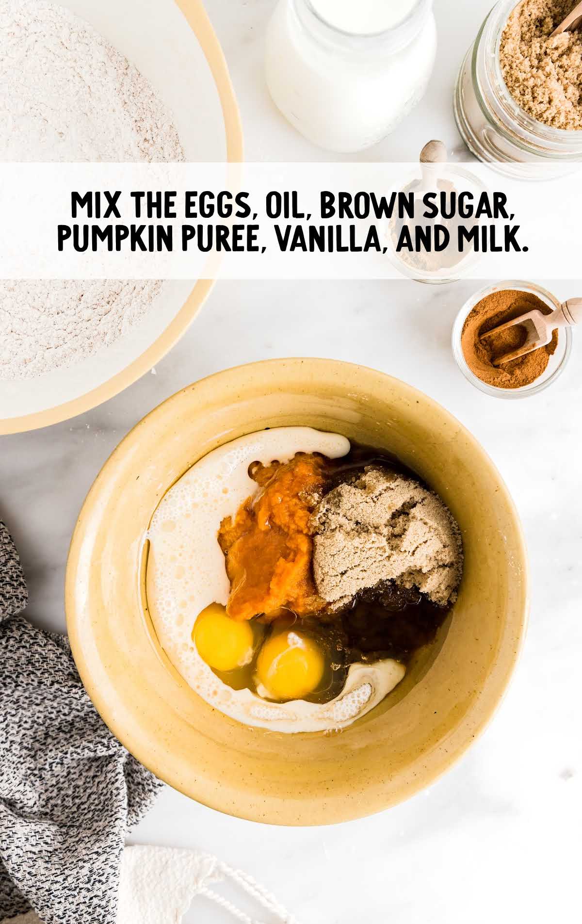 eggs, oil, brown sugar, pumpkin puree, vanilla, and milk mixed in a bowl