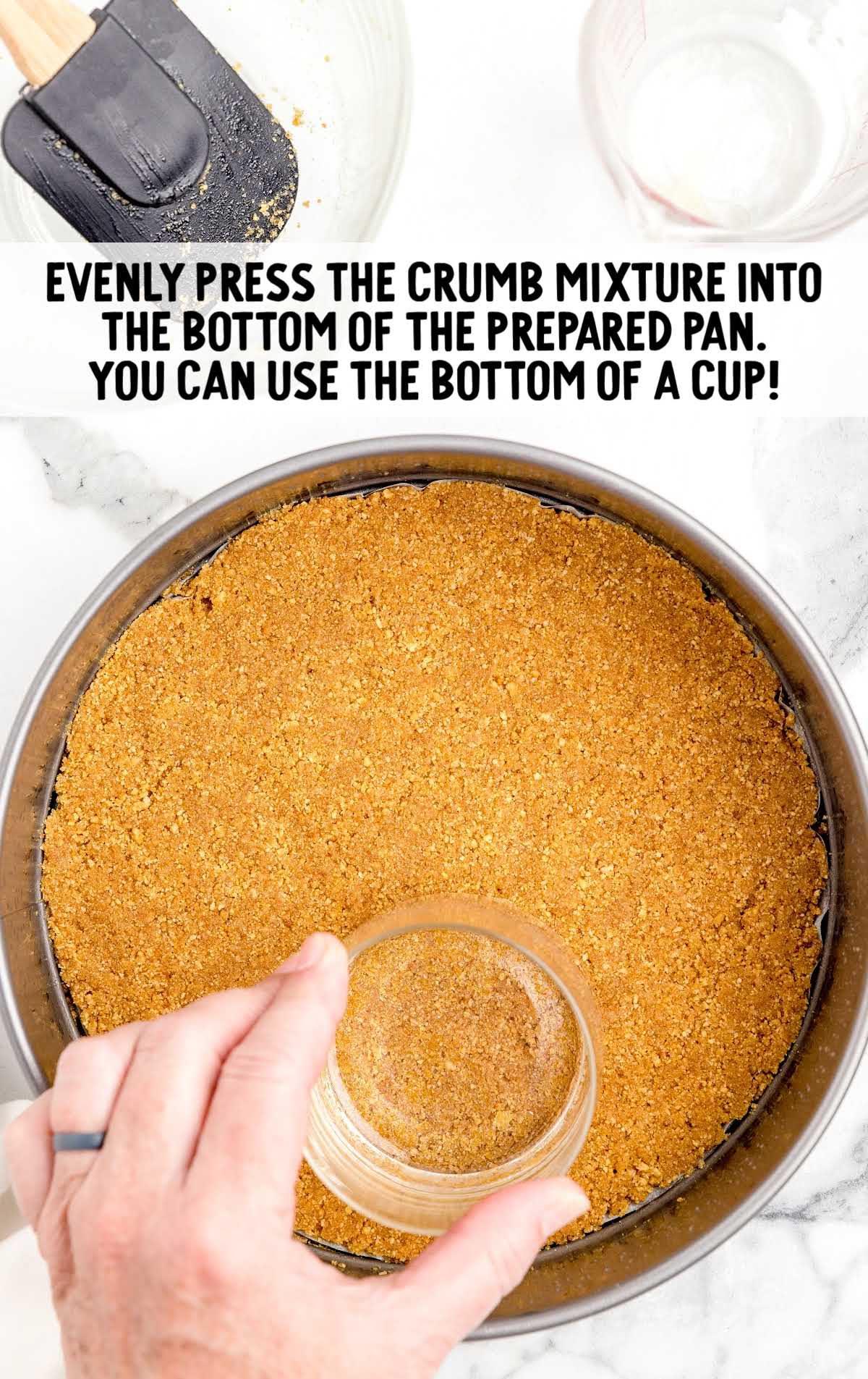 crumb mixture being pressed into a pan