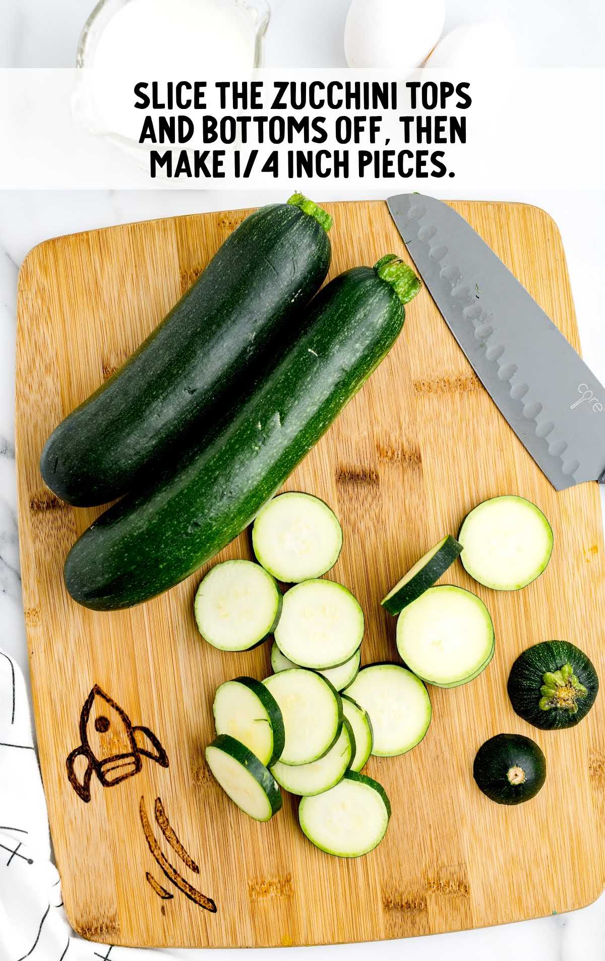 sliced top and bottom of zucchini on a wooden board