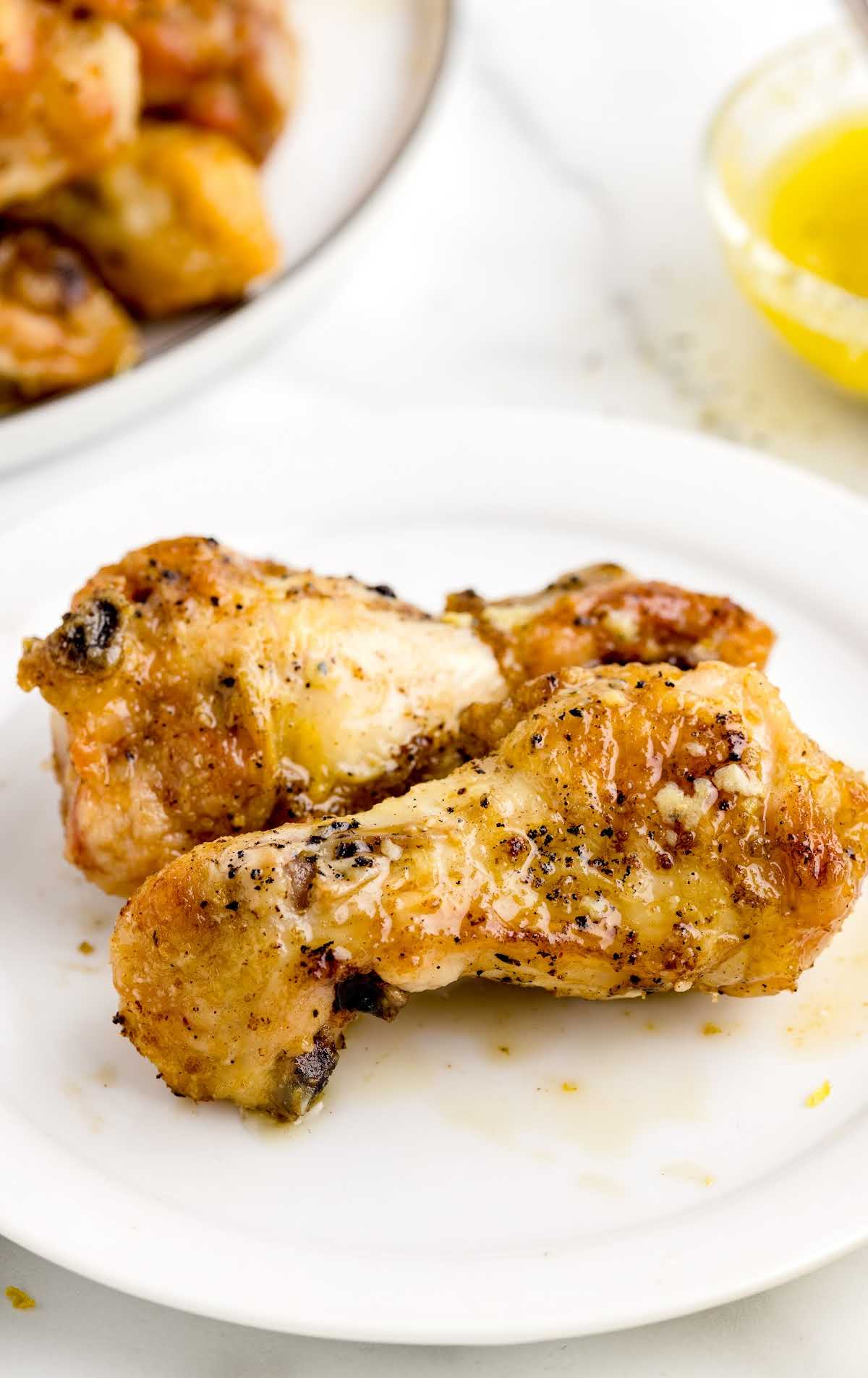 close up shot of two Lemon Pepper Wings on a plate