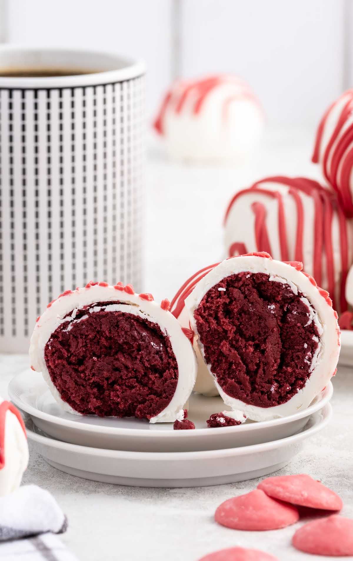 a close up shot of a Red Velvet Cheesecake Bite split in half on a plate