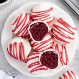 overhead shot of Red Velvet Cheesecake Bites on a plate with one split in half