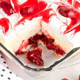 strawberry cake in a baking dish with a slice missing