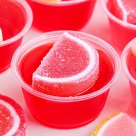 close up shot of Strawberry Lemonade Jello Shots topped with fruit gummies