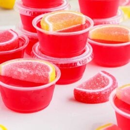 close up shot of Strawberry Lemonade Jello Shots topped with fruit gummies