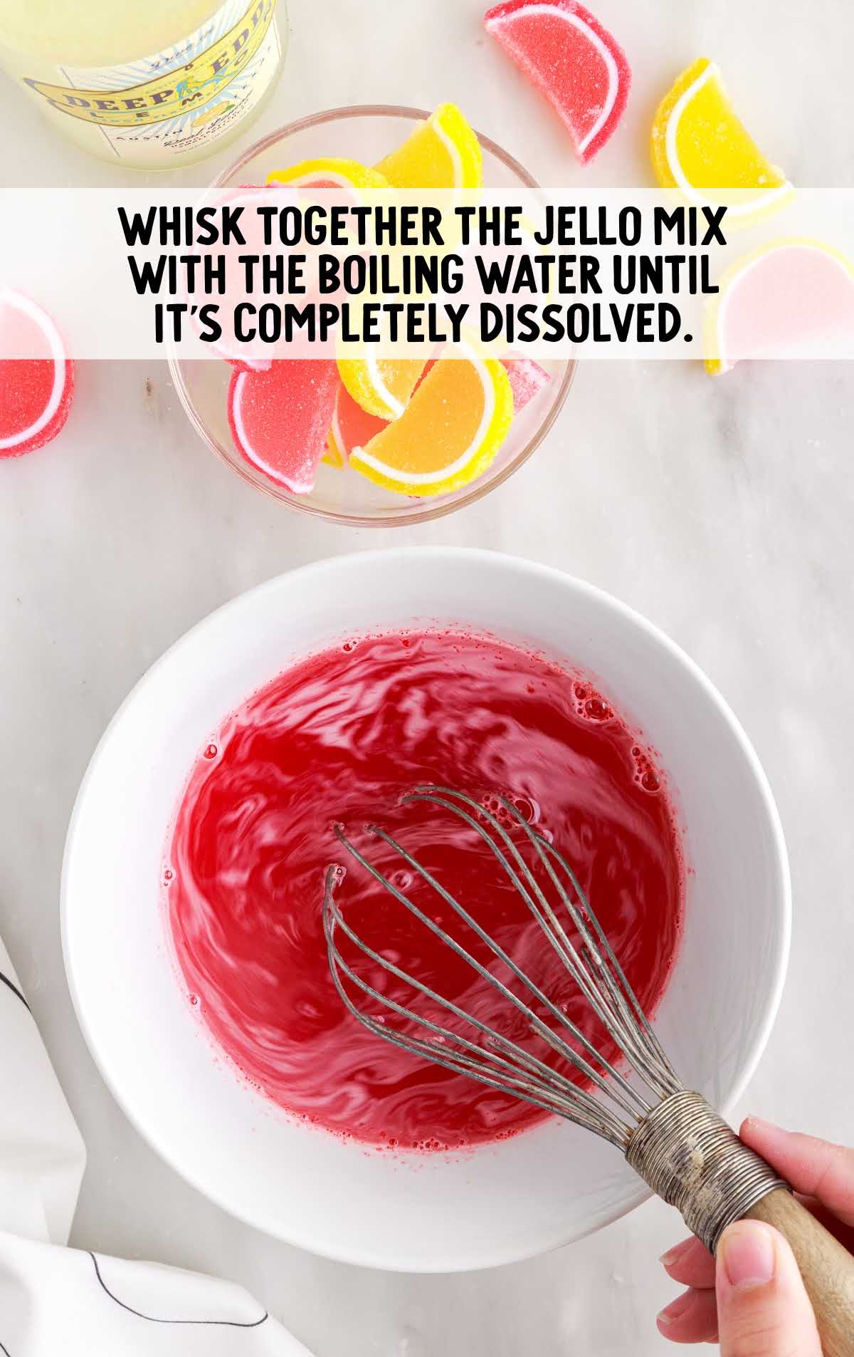 jello mix and boiling water whisked in a bowl