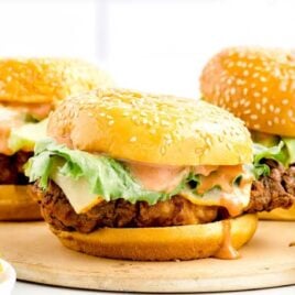 close up shot of Zinger Burgers on a wooden board