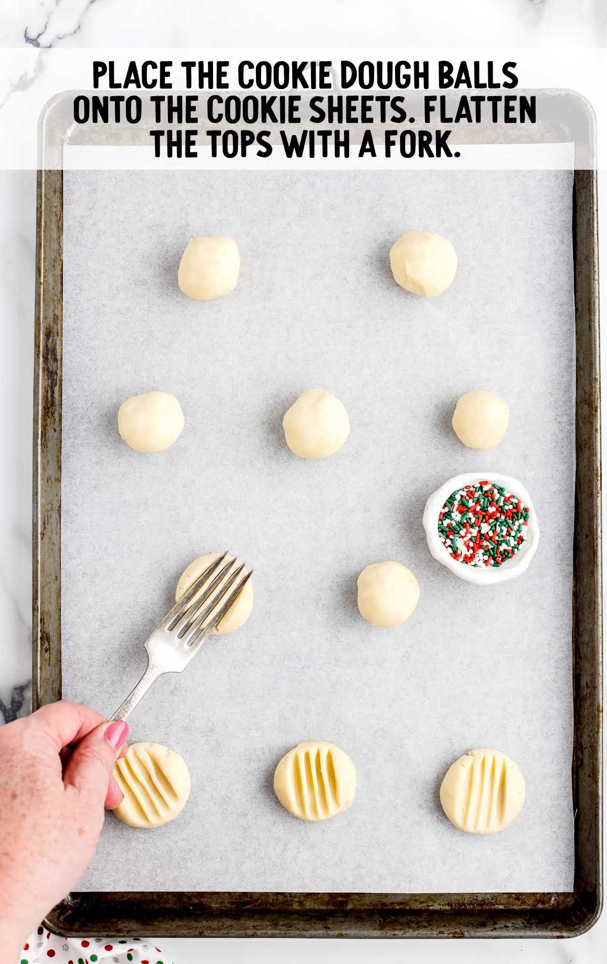 cookie dough balls placed onto cookie sheet