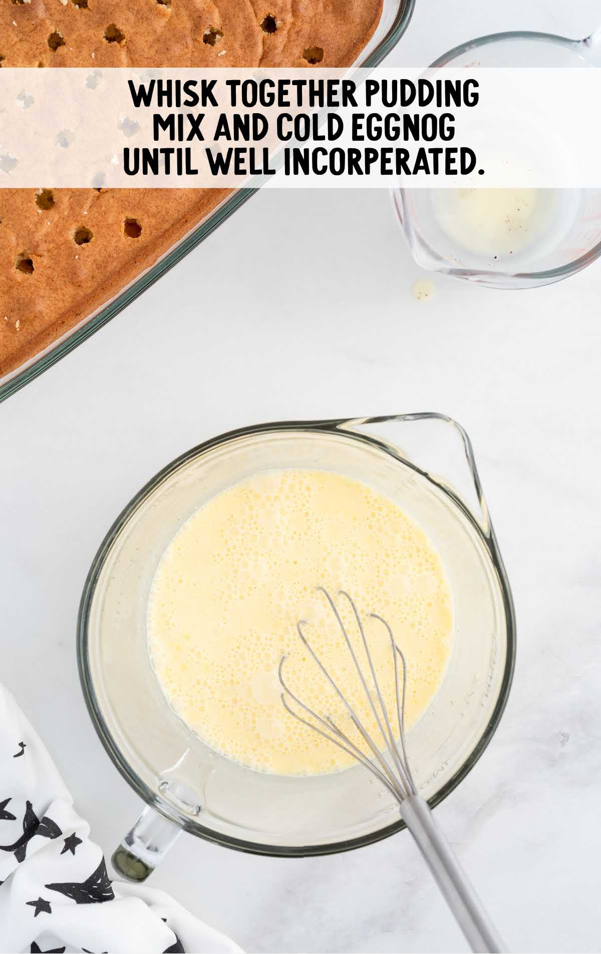 pudding and cold eggnog whisked in a measuring cup