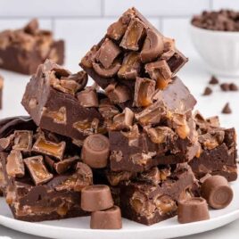 a close up shot of pieces of Rolo Fudge stacked on top of each other on a plate