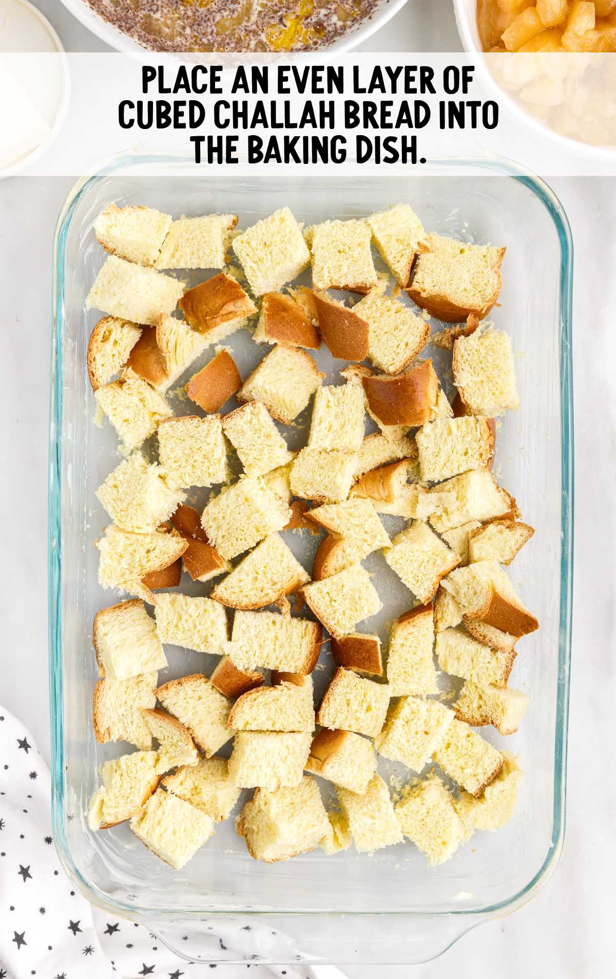 cubed challah bread placed into the baking dish