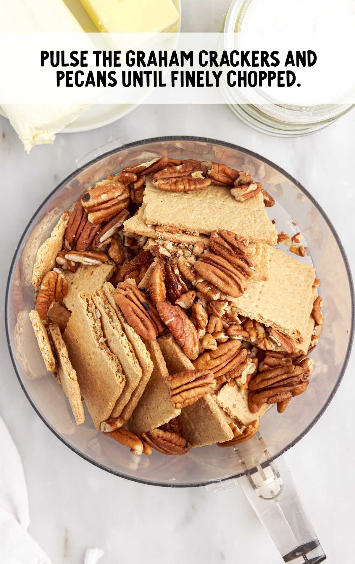 graham crackers and pecans pulsed together in a bowl