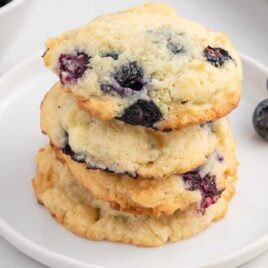 close up shot of Blueberry Cheesecake Cookies stacked on top of each other on a plate