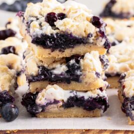 a close up shot of pieces of Blueberry Pie Bars stacked on top of each other