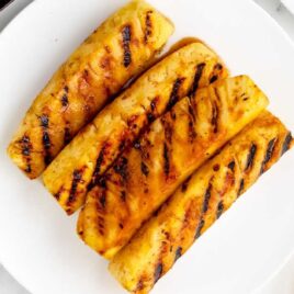 overhead shot of pieces of Brown Sugar Grilled Pineapple on a plate