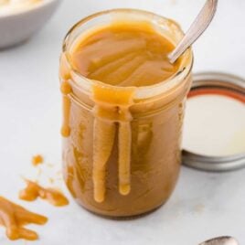 a close up shot of Butterscotch Sauce in a mason jar