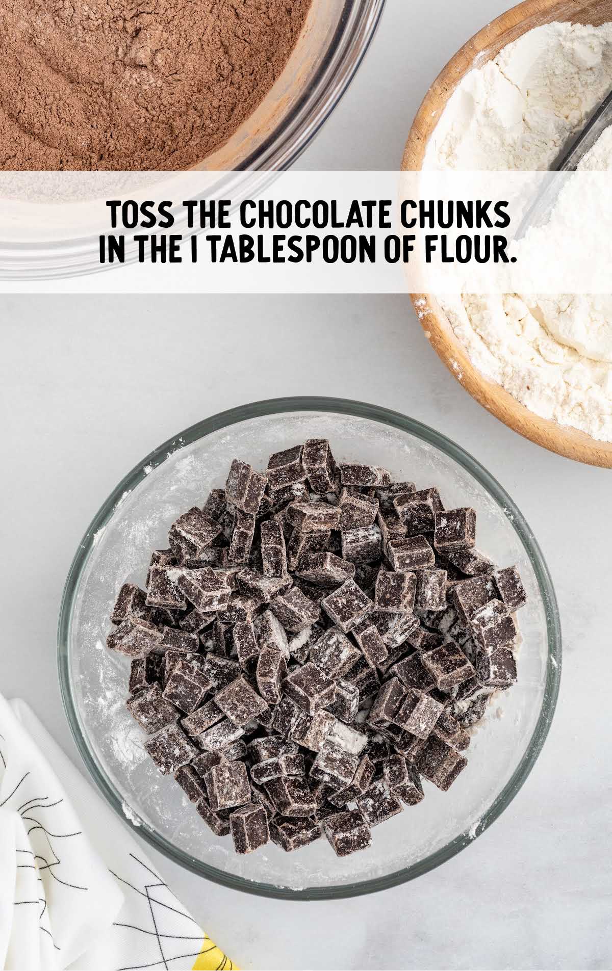 flour and chocolate chunks tossed in a bowl