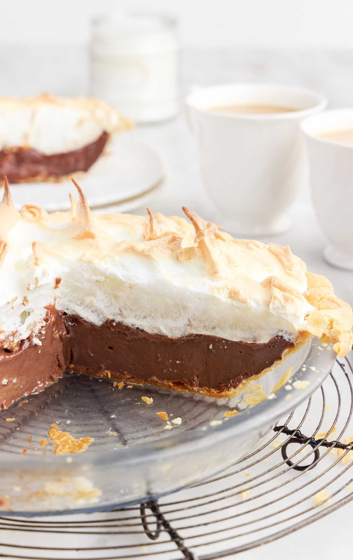 a close up shot of a Chocolate Meringue Pie with a slice taken out