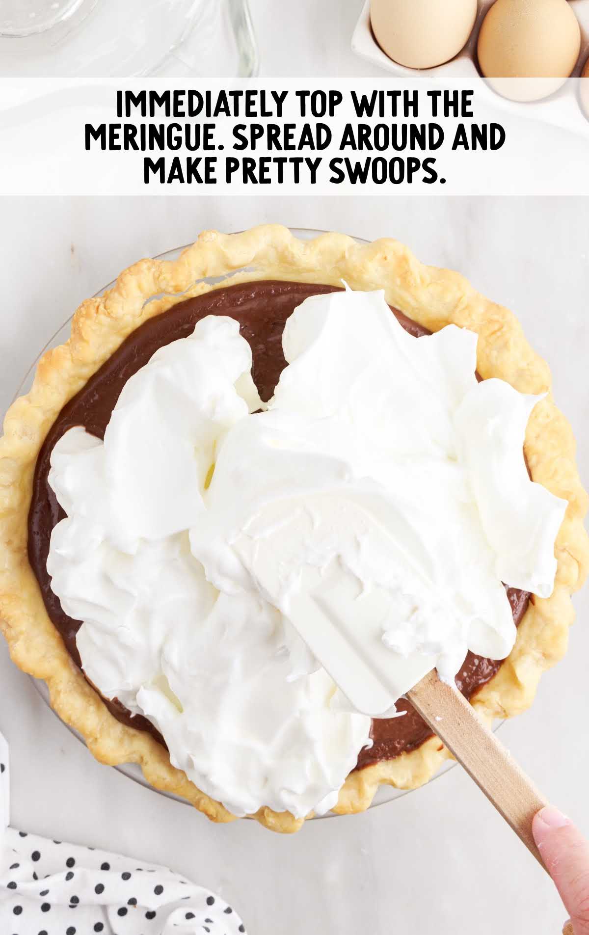 pie topped with meringue with a spatula