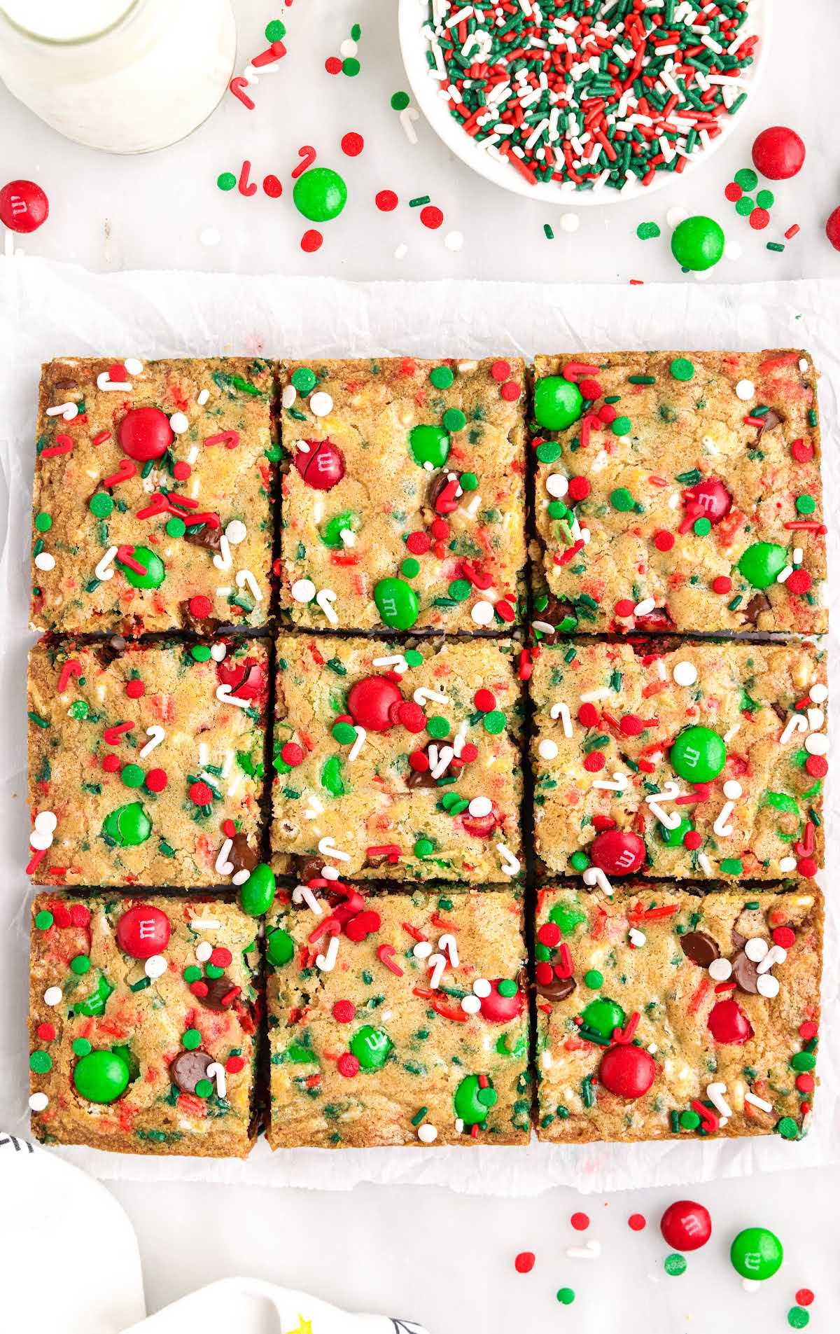 overhead shot of Christmas cookie bars on a parchment sheet