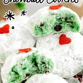 a close up shot of Grinch Snowball Cookies with one split in half on a plate