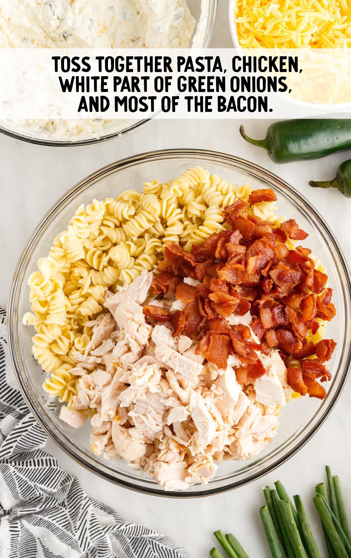 pasta, chicken, and bacon tossed in a bowl