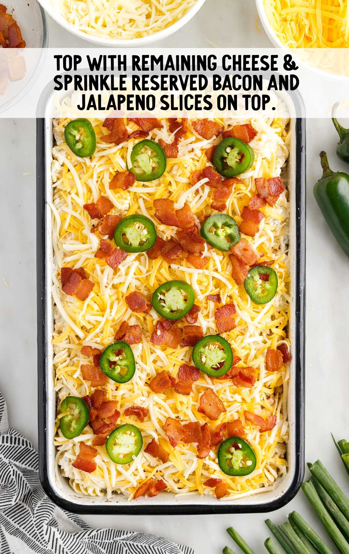 sprinkle cheese and place bacon and Jalapeño slices on top in a baking dish