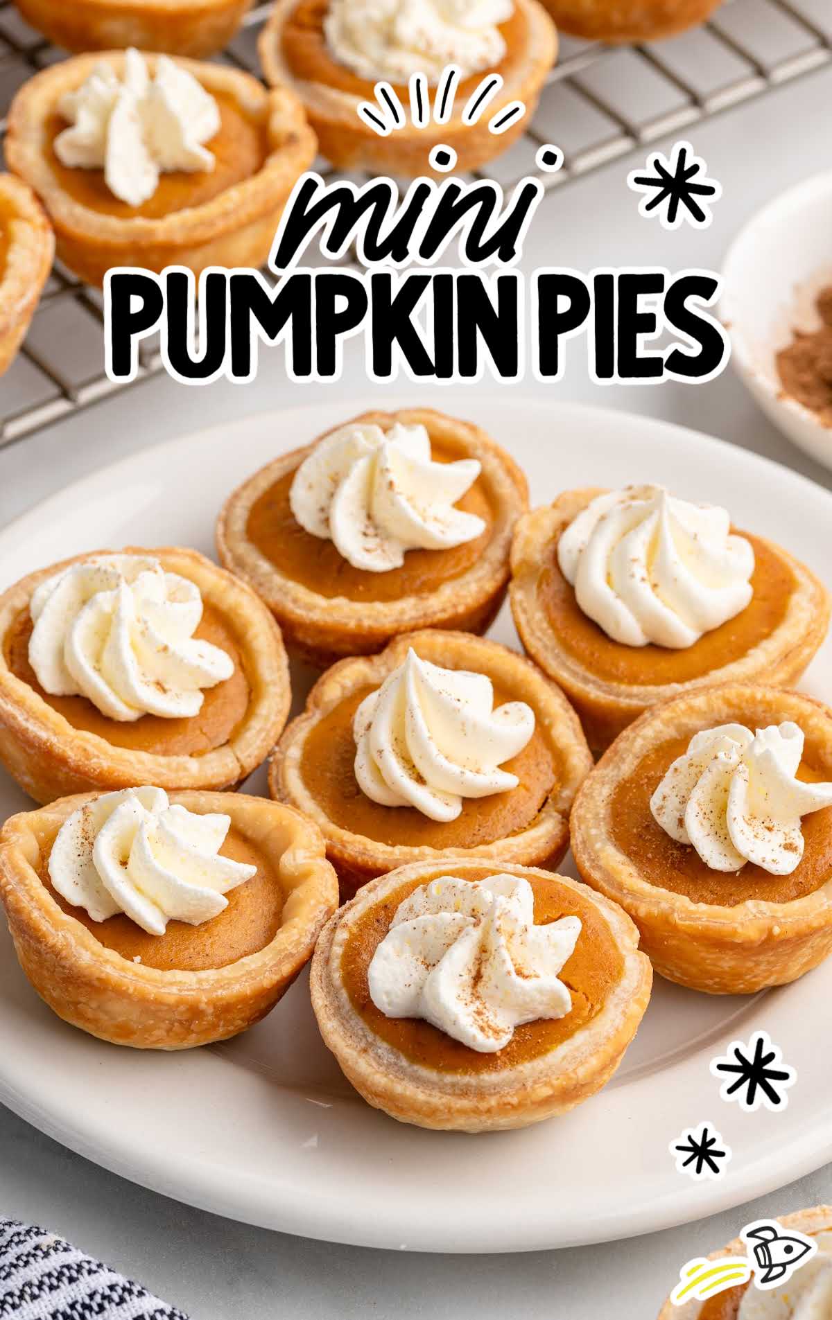 Plate of bite-sized pumpkin pies with whipped cream dollops