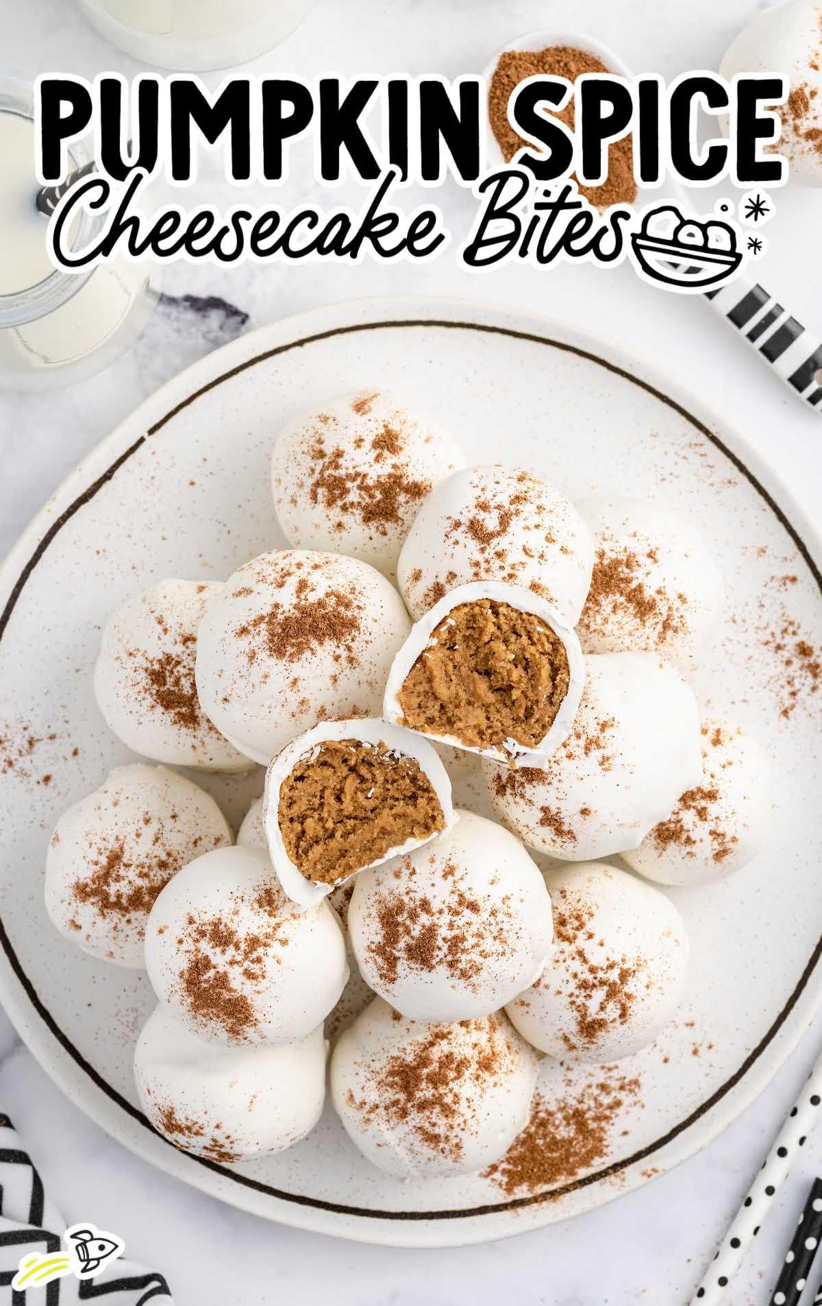 overhead shot of Pumpkin Spice Cheesecake Bites on a plate with one split in half