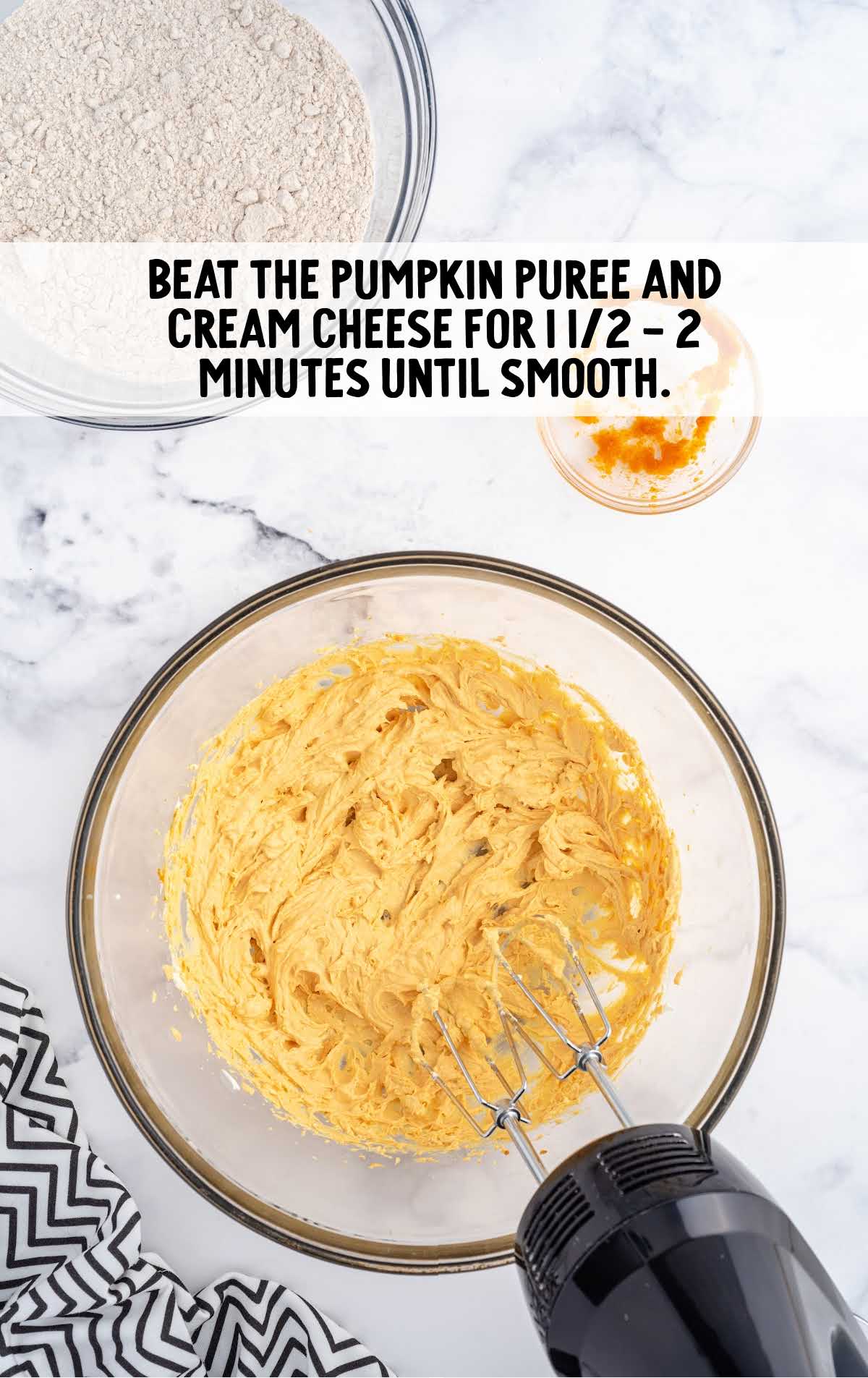 pumpkin puree and cream cheese blended in a bowl