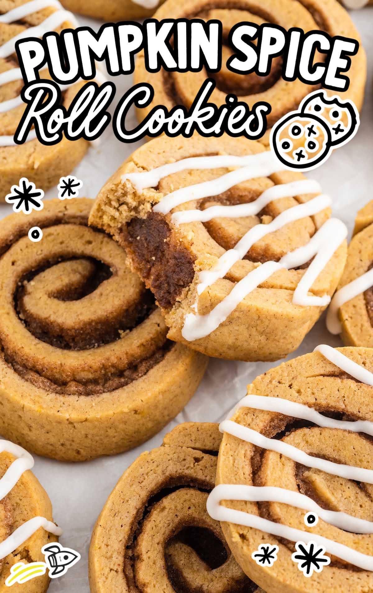 a close up shot of Pumpkin Spice Roll Cookies with one having a bite taken out of it