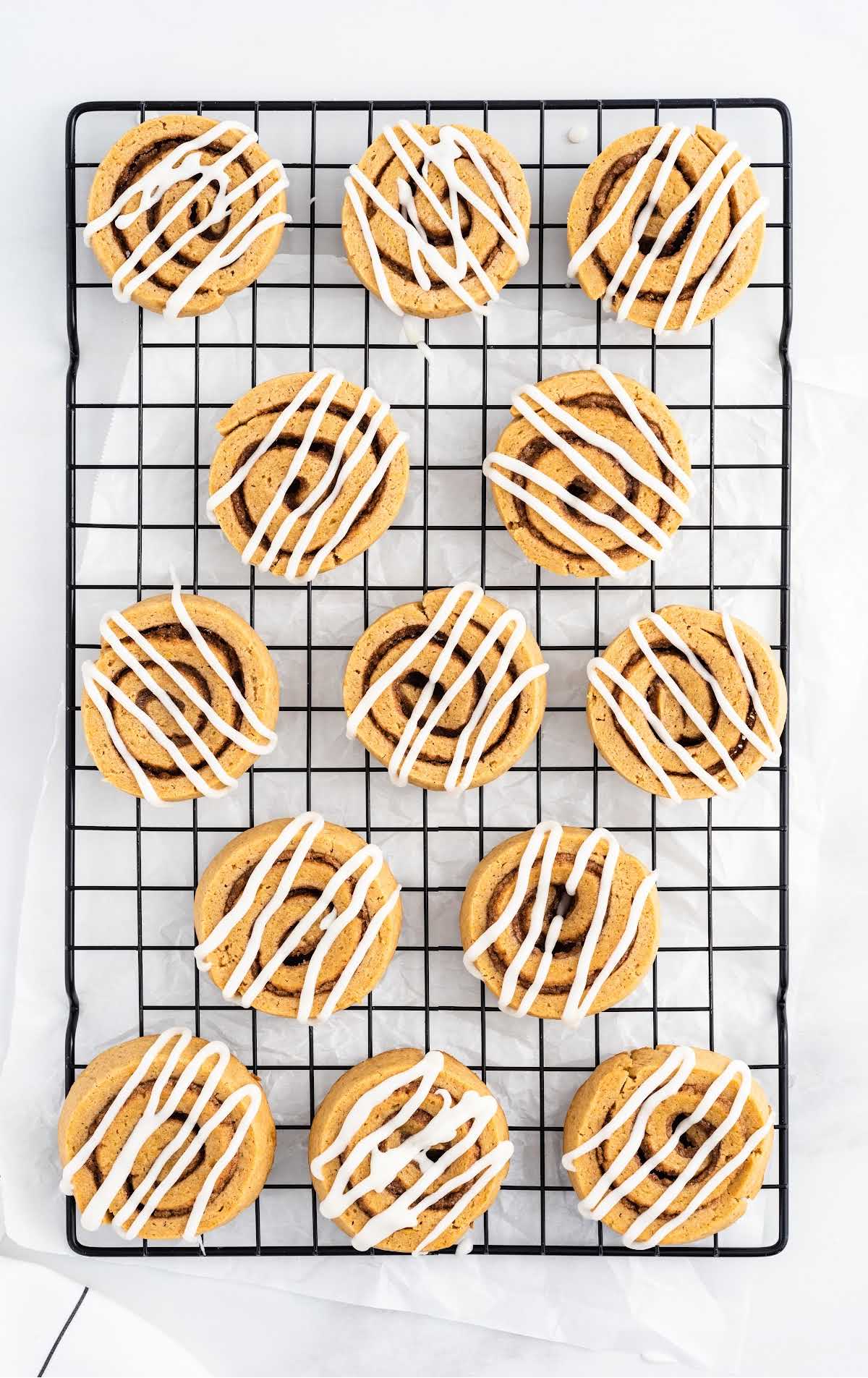 a close up shot of Pumpkin Spice Roll Cookies on a cooling rack