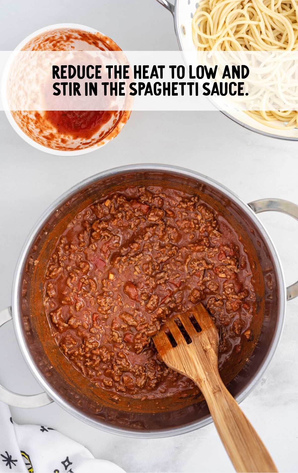 spaghetti sauce stirred in a pot