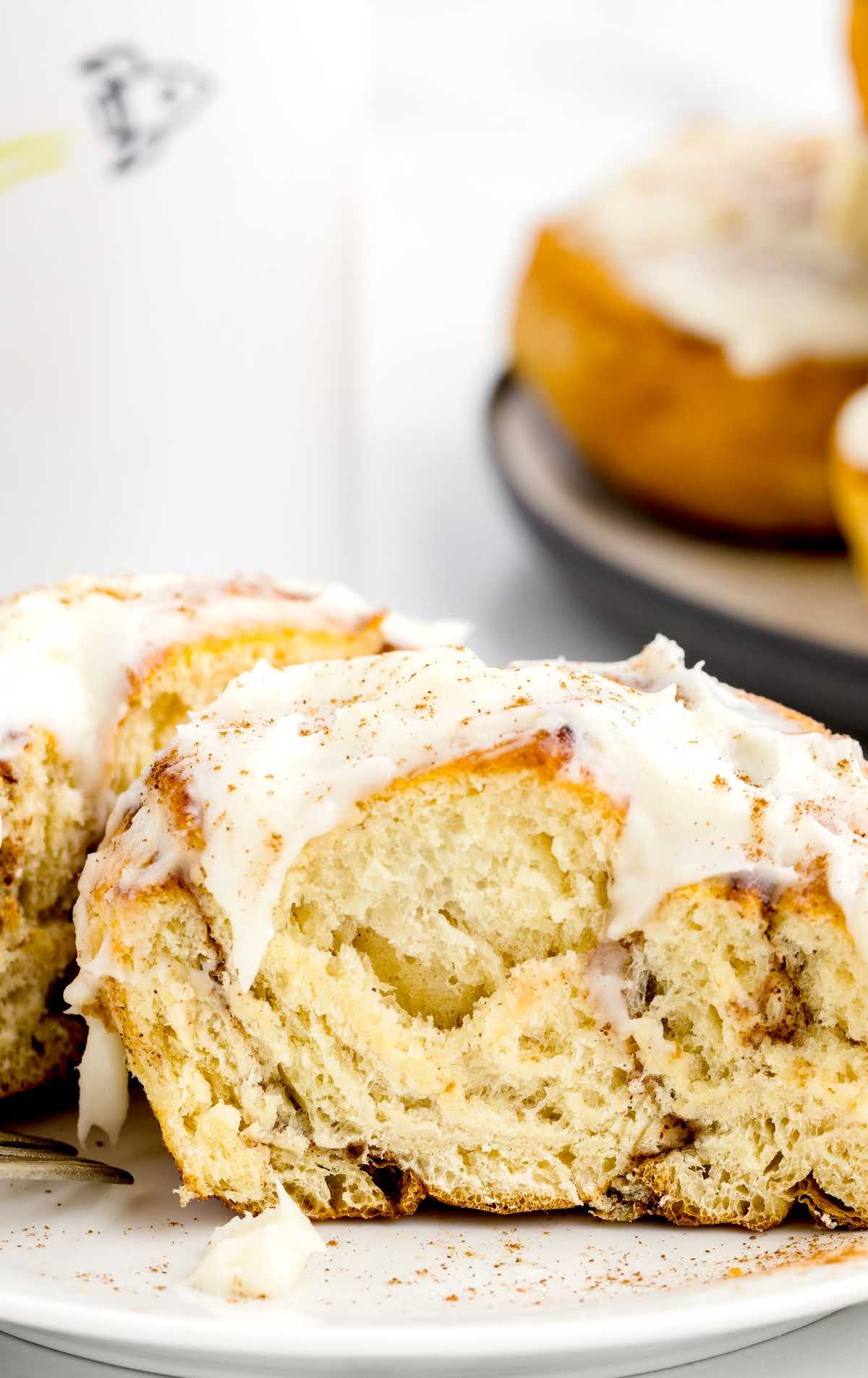 a close up shot of a Air Fryer Cinnamon Roll split in half on a plate