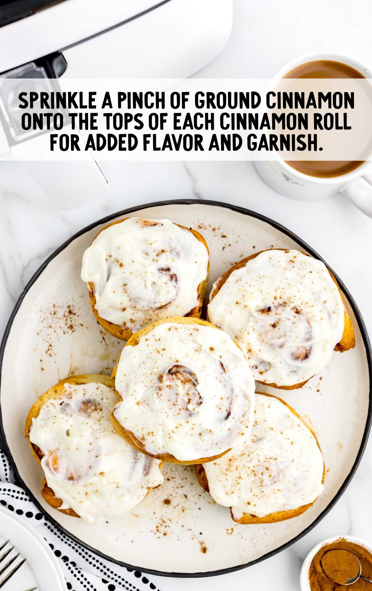 ground cinnamon sprinkled on top of each roll on a plate