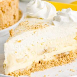 a close up shot of a slice of Banana Cream Cheesecake on a plate