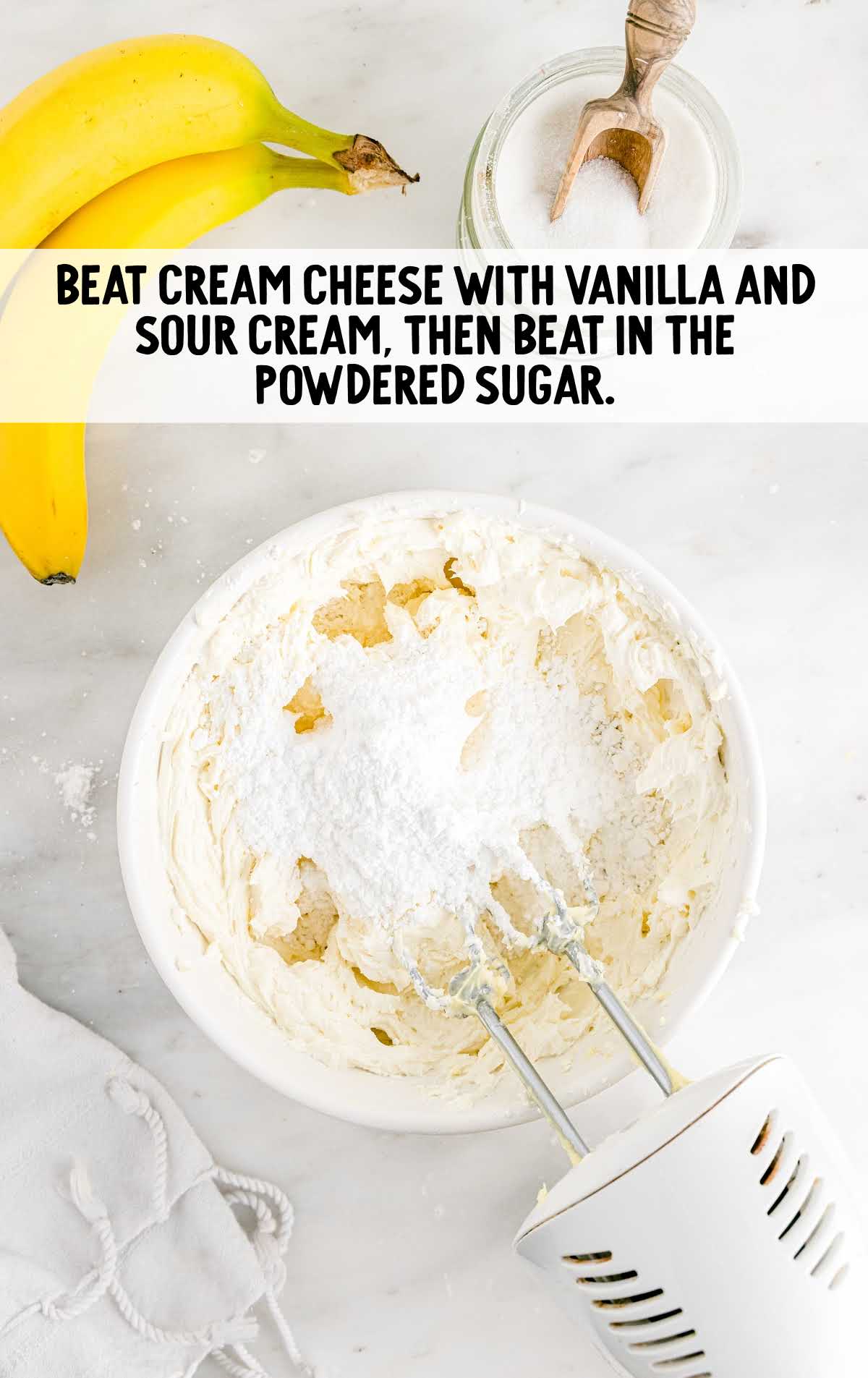 cream cheese, vanilla, and sour cream blended in a bowl
