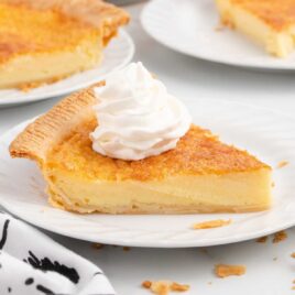 a close up shot of a slice of Buttermilk Pie on a plate
