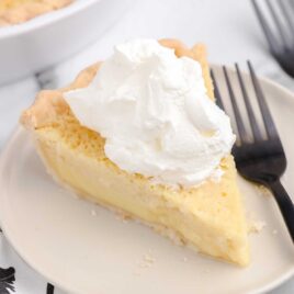 a close up shot of a slice of Buttermilk Pie on a plate