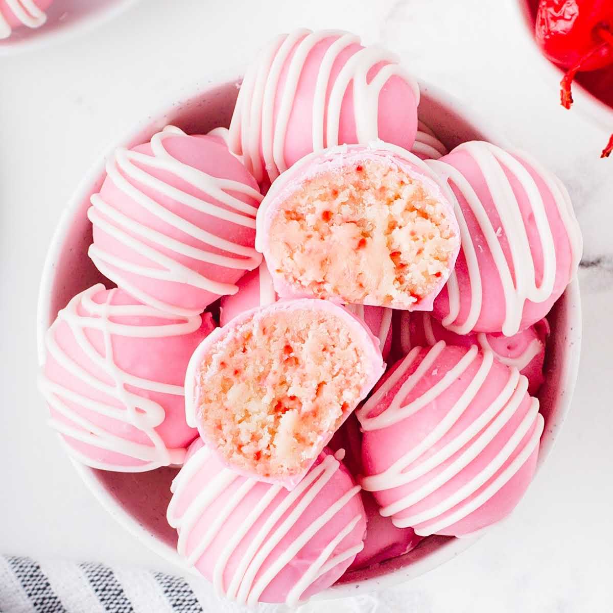 overhead shot of Cherry Chip Cheesecake Bites with one split in half in a bowl