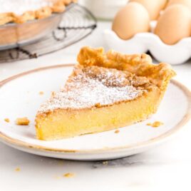 a close up shot of a slice of Chess Pie on a plate
