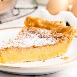 a close up shot of a slice of Chess Pie on a plate
