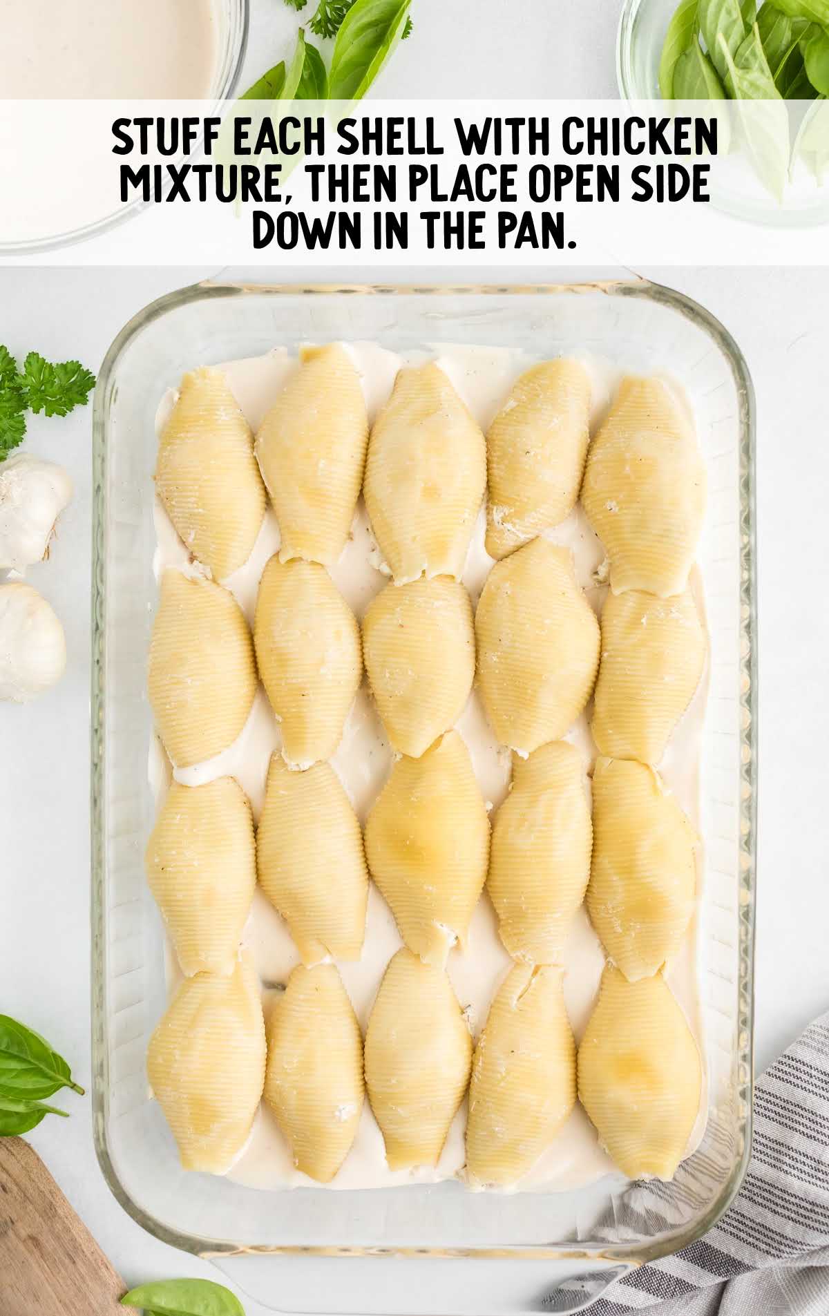chicken mixture stuffed in each shell in a baking dish