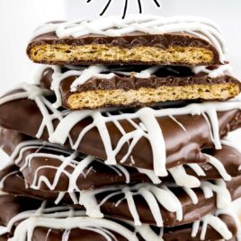 close up shot of Chocolate Covered Graham Crackers on a plate stacked on top of each other with one split in half