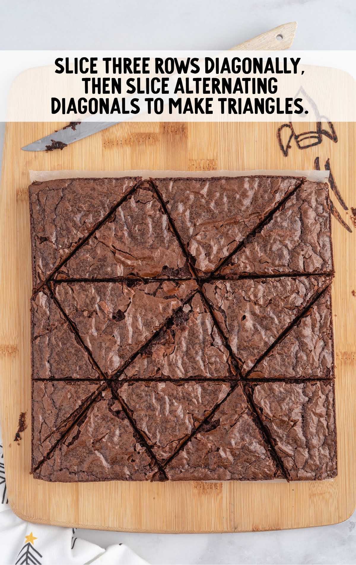 slice brownies into diagonally slices to make triangles on a wooden board