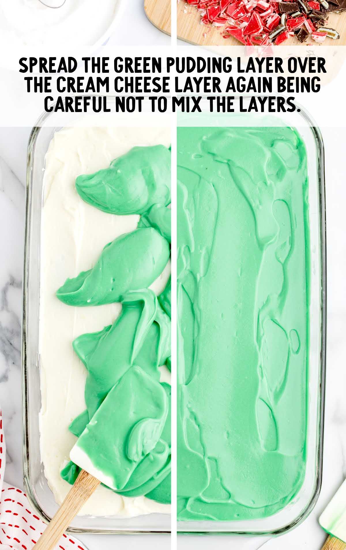 green pudding spread over the cream cheese layer in a baking dish
