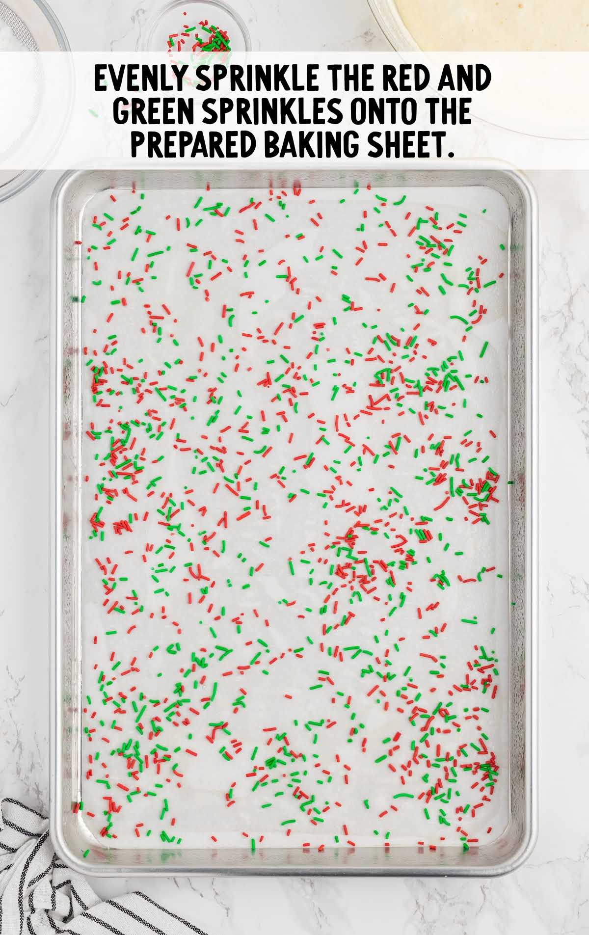 red and and green sprinkles sprinkled onto the baking sheet