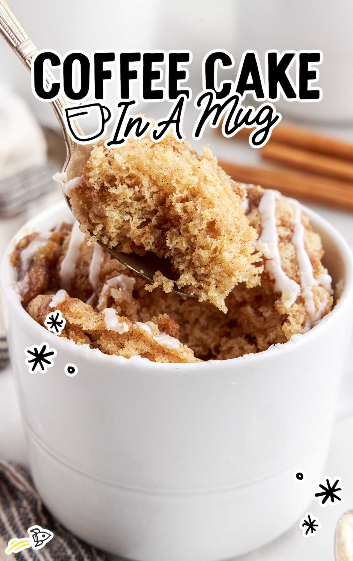a close up shot of Coffee Cake in a Mug with a spoon grabbing a piece